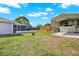 Expansive backyard with covered patio, grass and a large carport at 7205 Pinehurst Dr, Spring Hill, FL 34606