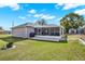 Large backyard features a covered patio, lush lawn and storage shed at 7205 Pinehurst Dr, Spring Hill, FL 34606