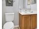 Clean bathroom featuring a modern vanity, toilet, and a mirror at 7205 Pinehurst Dr, Spring Hill, FL 34606