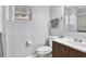 Clean bathroom featuring a modern vanity, toilet, and a mirror at 7205 Pinehurst Dr, Spring Hill, FL 34606