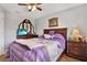 Inviting bedroom with wood floors, ceiling fan and furniture at 7205 Pinehurst Dr, Spring Hill, FL 34606