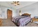 Bedroom featuring plush carpeting, ceiling fan and a large window for ample natural light at 7205 Pinehurst Dr, Spring Hill, FL 34606