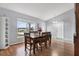 Bright dining room with a view, featuring hardwood floors and a classic wood table set at 7205 Pinehurst Dr, Spring Hill, FL 34606