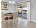 Cozy dining room featuring a round table with seating for four and sliding doors to patio at 7205 Pinehurst Dr, Spring Hill, FL 34606