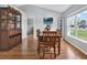 Dining room with hardwood floors and lots of natural light from the large picture window at 7205 Pinehurst Dr, Spring Hill, FL 34606