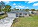 Charming single-story home with a well-manicured lawn and mature trees at 7205 Pinehurst Dr, Spring Hill, FL 34606