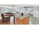 Open-concept layout connecting the living room and dining area with stylish breakfast bar at 7205 Pinehurst Dr, Spring Hill, FL 34606