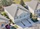 Aerial capturing the home's architectural design, emphasizing the roof, windows, and surrounding landscape at 7624 Red Mill Cir, New Port Richey, FL 34653