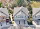 Aerial view of multiple townhomes with garages, balconies, and well-maintained landscaping in a neighborhood at 7624 Red Mill Cir, New Port Richey, FL 34653