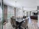 Dining room boasts a modern light fixture, geometric wall design, and seating for six at 7624 Red Mill Cir, New Port Richey, FL 34653