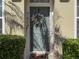 Front door with wreath and plantings leading to a warm welcome and inviting entrance at 7624 Red Mill Cir, New Port Richey, FL 34653