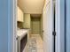 Laundry room featuring tile floors, storage cabinets and modern washer and dryer appliances at 7624 Red Mill Cir, New Port Richey, FL 34653