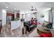 Open-concept living room featuring a kitchen view, cozy sofa, and a view of the dining area at 7624 Red Mill Cir, New Port Richey, FL 34653