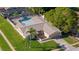 Aerial view of a well-maintained home featuring a private backyard pool at 7901 Willow Brook Ct, Hudson, FL 34667