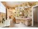 Charming bathroom with floral wallpaper, a double sink vanity, and large mirrors at 7901 Willow Brook Ct, Hudson, FL 34667