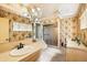 Charming bathroom with floral wallpaper, a glass enclosed shower, and vanity at 7901 Willow Brook Ct, Hudson, FL 34667