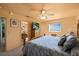 Comfortable bedroom with neutral tones, ceiling fan and large TV screen on a wooden dresser at 7901 Willow Brook Ct, Hudson, FL 34667