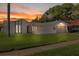 Charming single-story home featuring a two-car garage, desert landscaping, and an American flag at 7901 Willow Brook Ct, Hudson, FL 34667
