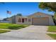 Charming single-story home featuring a two-car garage, desert landscaping, and an American flag at 7901 Willow Brook Ct, Hudson, FL 34667