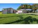 Charming single-story home featuring a two-car garage, desert landscaping, and an American flag at 7901 Willow Brook Ct, Hudson, FL 34667