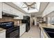 White cabinets complement this kitchen with granite countertops and black appliances, creating a sleek and modern feel at 7901 Willow Brook Ct, Hudson, FL 34667