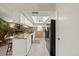 Modern kitchen with stone accent wall, breakfast bar, and sleek black appliances at 7901 Willow Brook Ct, Hudson, FL 34667