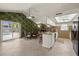 Open-concept kitchen and dining area with stone accents, access to the pool, and ample natural light at 7901 Willow Brook Ct, Hudson, FL 34667