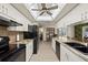Bright kitchen featuring white cabinets, granite countertops and stainless steel appliances with a view to the dining area at 7901 Willow Brook Ct, Hudson, FL 34667