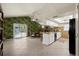 Open-concept kitchen and dining area with stone accents, access to the pool, and ample natural light at 7901 Willow Brook Ct, Hudson, FL 34667