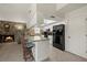 Modern kitchen with stone accent wall, breakfast bar, and sleek black appliances at 7901 Willow Brook Ct, Hudson, FL 34667