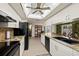 Bright kitchen with white cabinets, granite countertops, a tile backsplash, and stainless steel appliances at 7901 Willow Brook Ct, Hudson, FL 34667