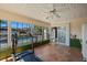 Bright sunroom with tiled floors and large windows, offering tranquil views of the pool and outdoor area at 7901 Willow Brook Ct, Hudson, FL 34667