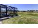 View of the backyard with screened-in pool and surrounding homes at 8609 Regal Ln, Hudson, FL 34667