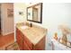 Bathroom with stone countertop, wooden cabinetry, and neutral paint at 8609 Regal Ln, Hudson, FL 34667