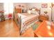 Cozy bedroom with hardwood floors, complemented by a colorful floral painting at 8609 Regal Ln, Hudson, FL 34667