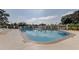 Enjoy this community pool with plenty of sunshine, seating, and an umbrella for shade at 8609 Regal Ln, Hudson, FL 34667