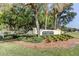 A manicured community sign surrounded by mature trees and landscaping to welcome residents and guests at 8609 Regal Ln, Hudson, FL 34667