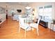 Bright dining area with glass table, hardwood floors, and views into the living room at 8609 Regal Ln, Hudson, FL 34667