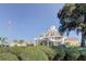 Exterior of community clubhouse with blue sky, green bushes, and American flag at 8609 Regal Ln, Hudson, FL 34667