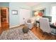 Comfortable home office with chair, workspace, decorative rug, closet and lots of natural light from the large windows at 8609 Regal Ln, Hudson, FL 34667