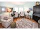 Comfortable home office with dual workstations, chair, decorative rug, and lots of natural light from the large windows at 8609 Regal Ln, Hudson, FL 34667