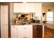 Functional kitchen with white cabinets, granite countertops, and stainless-steel dishwasher at 8609 Regal Ln, Hudson, FL 34667