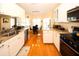 Bright kitchen with white cabinetry, granite countertops, and stainless-steel appliances at 8609 Regal Ln, Hudson, FL 34667