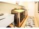 Laundry room with modern washer and dryer, tile flooring, and utility sink at 8609 Regal Ln, Hudson, FL 34667