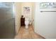 Bright bathroom features a toilet, tiled floor, a glass enclosed shower, and decorative wall art at 8609 Regal Ln, Hudson, FL 34667