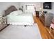 Elegant main bedroom with hardwood floors, neutral color scheme, tufted headboard, and mirrored bedside tables and dressers at 8609 Regal Ln, Hudson, FL 34667