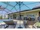Covered patio with lounge chairs and outdoor furniture overlooking the pool at 8609 Regal Ln, Hudson, FL 34667