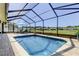 Screened-in pool with lounge chairs and view of the surrounding community at 8609 Regal Ln, Hudson, FL 34667