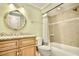 Bathroom featuring modern sink and vanity and tiled bathtub with shower at 8715 Christi Ct, Tampa, FL 33637