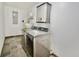 Laundry room with new washer and dryer, gray tile floor, and a modern cabinet above at 8715 Christi Ct, Tampa, FL 33637